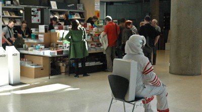 Some spaceman sitting in front of the bookshop at TYPO Berlin 2009
