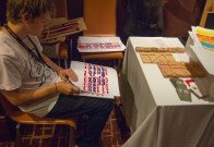 Nick Sherman signing prints of his newly designed, newly cut, wood type!